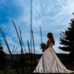 bride holding her bouquet looking out over a blue sky
