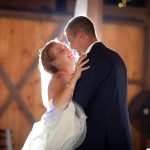 newlyweds swooning in each others arms in the barn