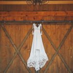 bride gown hanging from the barn doors